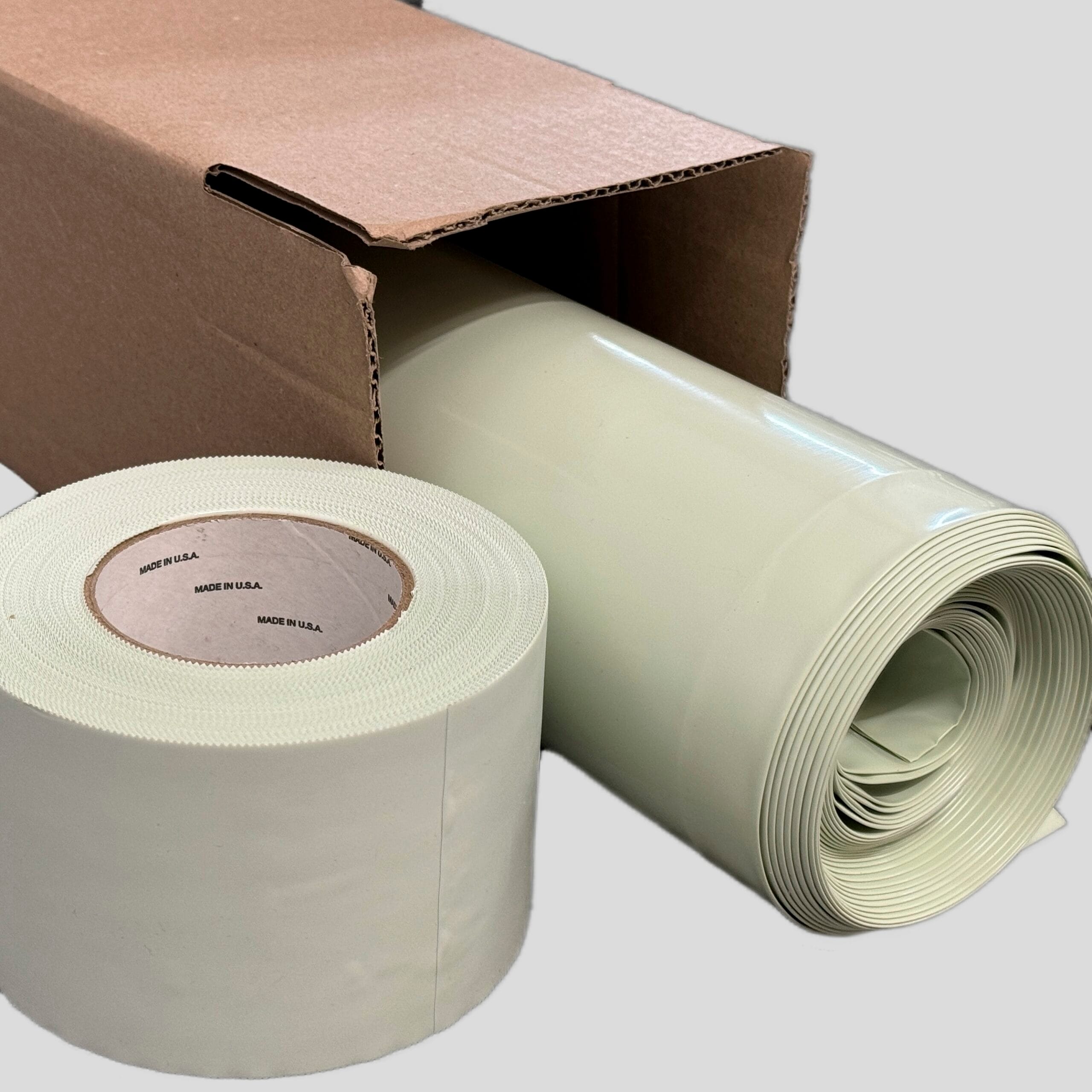 bioaqualife: A roll of light green flexible material partially unrolled beside an open cardboard box containing another roll of the same material. The box is plain, and the label on the roll reads "Made in U.S.A." on a circular paper core.